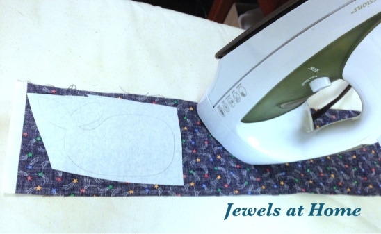 Cut out your design and iron it to the backside of the fabric.