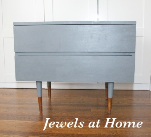 Mid-Century dresser painted in Benjamin Moore Amherst Gray with reverse "dipped" legs. Get the same look with a Ikea Sveio hack.  From Jewels at Home.