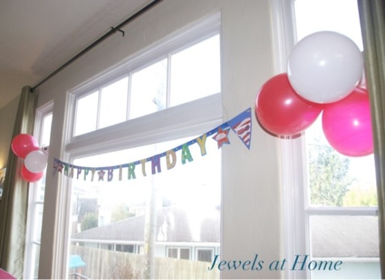 A plain banner customized for a firefighter birthday using removable decorations.  This banner can be used over and over again for different parties!  Jewels at Home.