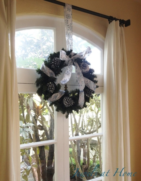 This wreath over a big french door can be enjoyed from the inside and out.  Christmas house tour from Jewels at Home.